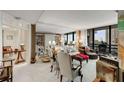 Bright living room features floor-to-ceiling windows with great views and comfortable seating areas at 2660 Peachtree Nw Rd # 10H, Atlanta, GA 30305