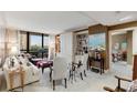 Cozy living room with built-in bookshelves, large windows, and neutral decor at 2660 Peachtree Nw Rd # 10H, Atlanta, GA 30305