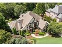 Aerial view of an estate home with lush landscaping, pool, spa and mature trees surrounding the property at 3770 Riverly Trce, Marietta, GA 30067