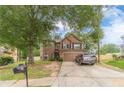 Attractive two-story home with stone accents, a two-car garage and a well-kept lawn at 568 Musical Ct, Lawrenceville, GA 30044