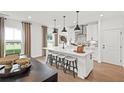 Modern kitchen with white cabinets, a center island with seating, and stainless steel appliances at 5760 Tillman Way, Powder Springs, GA 30127