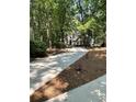 Traditional home features a long driveway, complemented by lush greenery and mature trees at 2901 Briscoe Rd, Loganville, GA 30052
