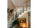Staircase with white spindles, a wooden handrail, and attractive decor at 2901 Briscoe Rd, Loganville, GA 30052