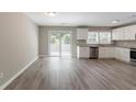 Spacious kitchen features white cabinets, granite countertops, stainless appliances and sliding glass doors at 2957 Browns Mill Se Rd, Atlanta, GA 30354