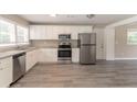 Bright kitchen features stainless steel appliances, white cabinetry, and granite countertops at 2957 Browns Mill Se Rd, Atlanta, GA 30354