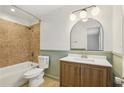 Bathroom featuring tub with tile surround, modern vanity with large mirror at 355 Winding River Dr # B, Atlanta, GA 30350