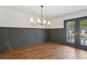 Dining room with stylish lighting fixture and views to outdoors from french doors at 355 Winding River Dr # B, Atlanta, GA 30350