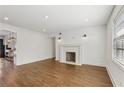 Open living room features a decorative fireplace, hardwood floors, and abundant natural light at 355 Winding River Dr # B, Atlanta, GA 30350