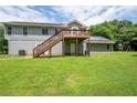 Expansive backyard with wooden deck and solar panels on house, perfect for outdoor activities and relaxation at 76 Vaughn Ne Rd, Cartersville, GA 30121
