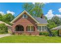 Charming brick home with a beautiful lawn and arched porch perfect for relaxing and enjoying the outdoors at 1391 Jefferson Ave, East Point, GA 30344