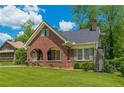 Charming brick home with a beautiful lawn and arched porch perfect for relaxing and enjoying the outdoors at 1391 Jefferson Ave, East Point, GA 30344