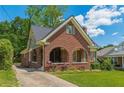 Charming brick home featuring a well-maintained front yard, arched porch and inviting curb appeal at 1391 Jefferson Ave, East Point, GA 30344