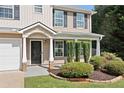 Close up of the charming front entrance with detailed landscaping and a covered porch at 174 Randall Dr, Rockmart, GA 30153