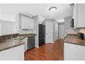 Kitchen area with stainless steel appliances, white cabinets, and tile backsplash at 174 Randall Dr, Rockmart, GA 30153