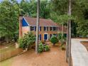 Charming two-story brick home with a dark blue front door and shutters at 3228 Turtle Lake Se Dr, Marietta, GA 30067