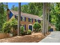 Charming two-story brick home with a dark blue front door and shutters at 3228 Turtle Lake Se Dr, Marietta, GA 30067