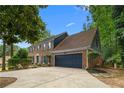 Charming two-story brick home with a dark blue front door and matching garage door at 3228 Turtle Lake Se Dr, Marietta, GA 30067