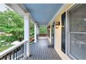 Inviting covered porch featuring classic columns and outdoor lighting fixtures at 2726 Riderwood Ne Ln, Marietta, GA 30062