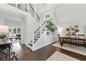 Stunning entryway showcasing modern staircase, dark wood floors, and ample natural light at 3065 Foxhall Overlook, Roswell, GA 30075