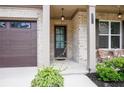Welcoming entryway with a dark-colored front door, brick facade, and a charming outdoor seating area at 2630 Timler Trce, Snellville, GA 30078