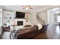 Cozy living room with a fireplace, built-in shelves, and comfortable leather furniture at 2630 Timler Trce, Snellville, GA 30078