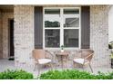 Inviting front porch features wicker chairs and a small table, creating a cozy outdoor seating area at 2630 Timler Trce, Snellville, GA 30078