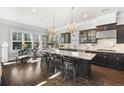 Gourmet kitchen with granite countertops, dark cabinetry, and stainless steel appliances, plus a large island at 1250 Atherton Park, Roswell, GA 30076