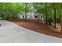 Landscaped front yard features a sprawling lawn and a private driveway to the house at 12995 Bucksport Dr, Roswell, GA 30075