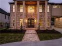 Elegant home entrance featuring a brick pathway and manicured landscaping at 157 Shadburn Ferry Rd, Buford, GA 30518