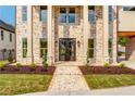 Elegant home entrance featuring a brick pathway and manicured landscaping at 157 Shadburn Ferry Rd, Buford, GA 30518