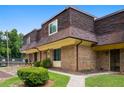 View of a brick townhouse with mature trees and a well-maintained lawn at 169 Peyton Sw Pl, Atlanta, GA 30311