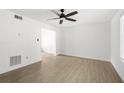 Spacious living area showcasing wood floors and neutral walls with view into adjacent room at 169 Peyton Sw Pl, Atlanta, GA 30311