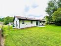 Spacious, grassy backyard with a sliding glass door leading to the home's interior at 4074 Green Hawk Trl, Decatur, GA 30035
