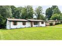 Beautifully landscaped front yard featuring a well-maintained lawn of a charming ranch home at 4074 Green Hawk Trl, Decatur, GA 30035