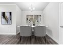 Elegant dining area showcasing stylish decor, a modern chandelier, and wood flooring at 791 Belrose Dr, Smyrna, GA 30080