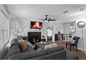 Comfortable living room featuring a fireplace, ceiling fan, and stylish furnishings at 392 Fourth St, Forest Park, GA 30297