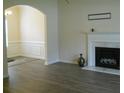 Cozy living room featuring a classic fireplace with marble accents and modern gray flooring at 4750 Crinklepoint Ct, Douglasville, GA 30134