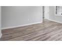 The bright living room is open and airy with modern flooring, fresh paint, and white trim at 6565 Bussell Way, Riverdale, GA 30274