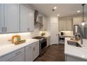Updated kitchen showcasing stainless steel appliances, white cabinets, and stylish countertops at 1005 Crown Oak St # 44, Johns Creek, GA 30022