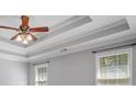Bedroom with a ceiling fan and beautiful trey ceiling design and natural light at 2525 Millwater Xing, Dacula, GA 30019