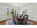 Formal dining room features elegant chandelier, large window, and refined decor at 340 Old York Rd, Johns Creek, GA 30097
