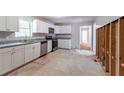Bright kitchen featuring white cabinets, stainless steel appliances, and granite countertops at 6293 Silver Creek Ln, Austell, GA 30168