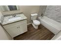 Updated bathroom featuring a granite vanity, modern fixtures, and tile accents at 1026 Eisenhower Se Ct, Atlanta, GA 30354