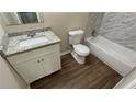 Bright bathroom features a modern vanity and tiled bathtub at 1026 Eisenhower Se Ct, Atlanta, GA 30354
