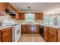 Spacious kitchen with wood cabinets, a double basin sink, and modern appliances at 2563 Creek Ter, Snellville, GA 30078
