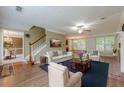 Cozy living room with a staircase and an adjoining dining room at 2563 Creek Ter, Snellville, GA 30078