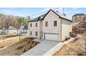 A bright, two-story home with a brick facade, a two-car garage, and a long driveway at 4420 Ross Estates Ct, Snellville, GA 30039