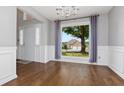 Bright dining room with hardwood floors, chair rail molding and an oversized window at 64 Harbour Lake Dr, Fayetteville, GA 30215