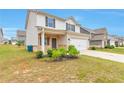 Attractive two-story house with a lush lawn, complemented by a two-car garage and manicured landscaping at 513 Moline Way, Locust Grove, GA 30248
