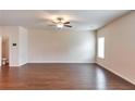 Expansive living room boasts gleaming hardwood floors, neutral paint, and abundant space for living at 513 Moline Way, Locust Grove, GA 30248